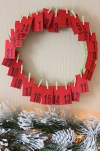 Numbered envelopes with activities enclosed, hung on a wreath